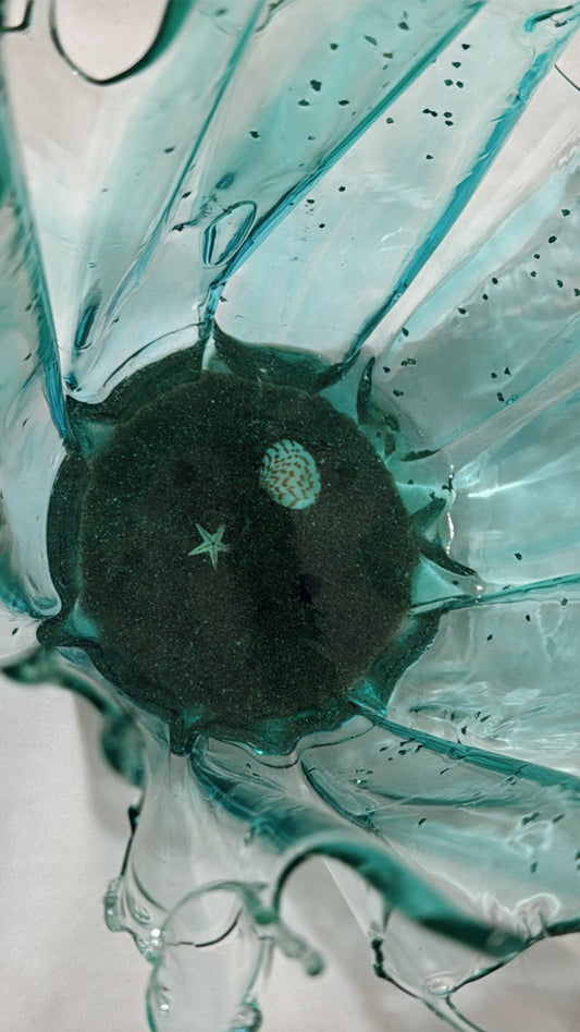 Close-up of a green glass vase with a star design on a white background