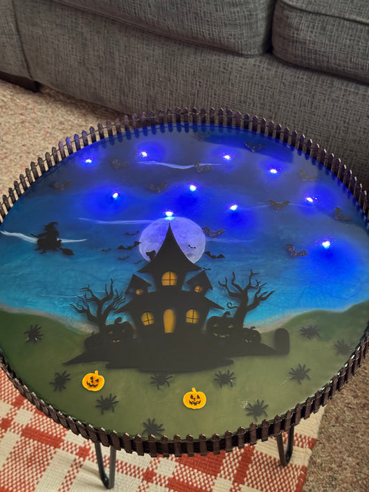 Halloween themed resin table with led bat lights inside.